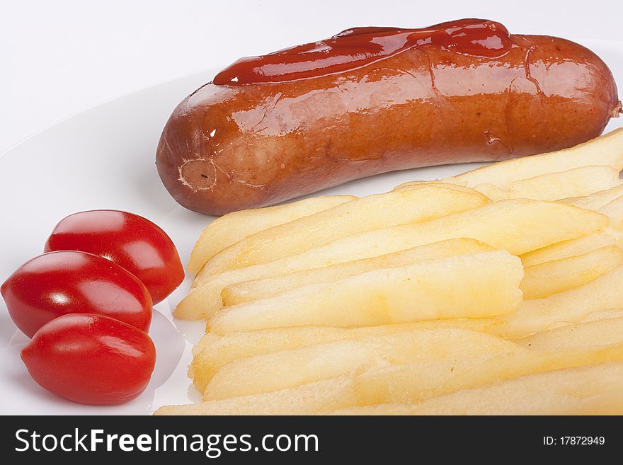 Sausage with a fried potato and tomatoes.