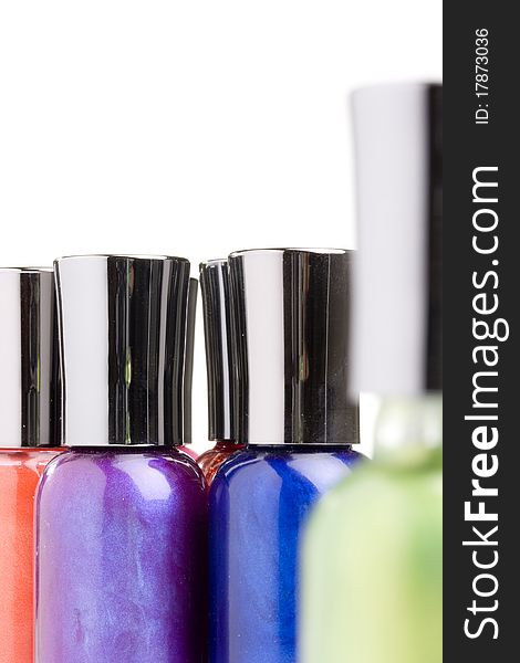 Different colored nail polish bottles on a white background.