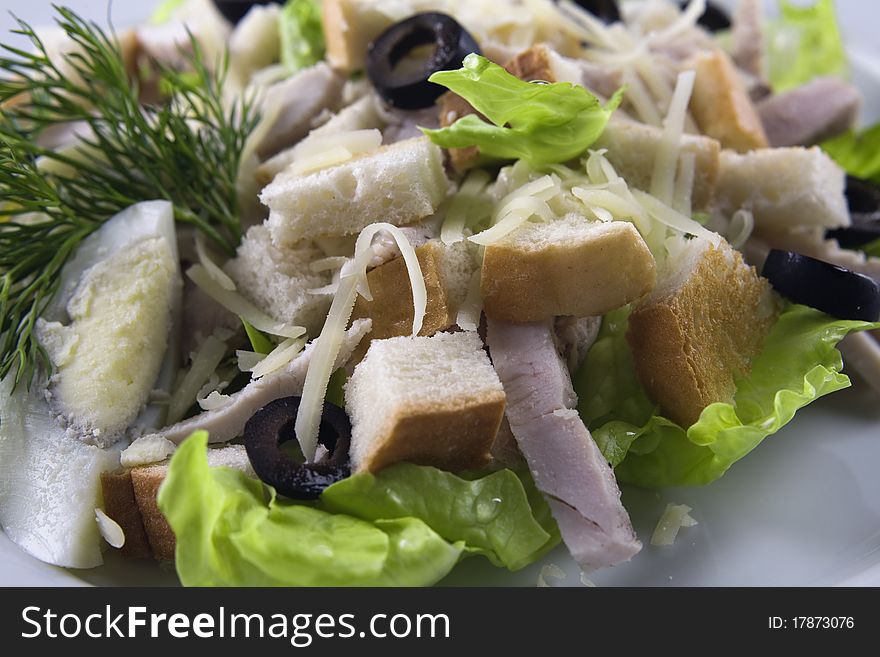 Chicken Caesar salad on white background close up