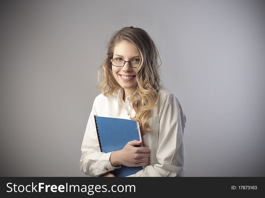 Smiling beautiful businesswoman holding a folder