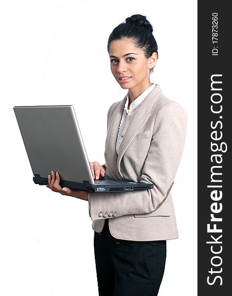 Young business woman holding a laptop isolated on white