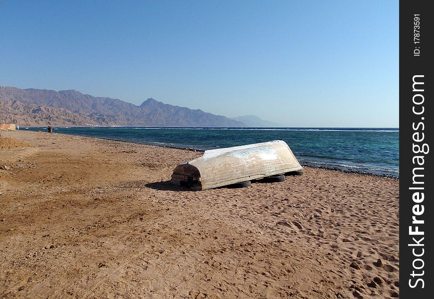 Lonely boat on the seacoast, Egypt, Dahab.