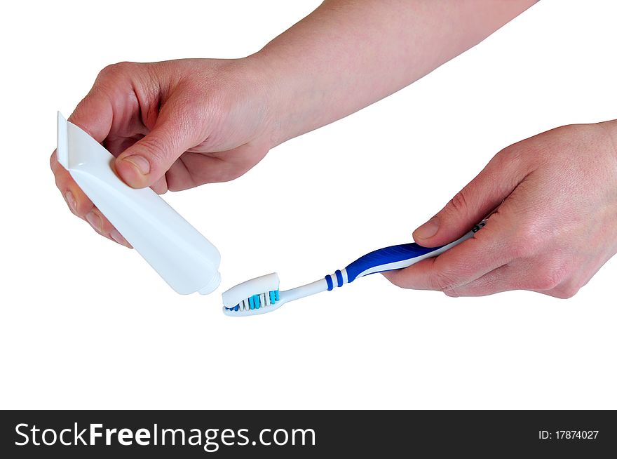 Picture of hands holding a toothbrush and container of cream. Picture of hands holding a toothbrush and container of cream