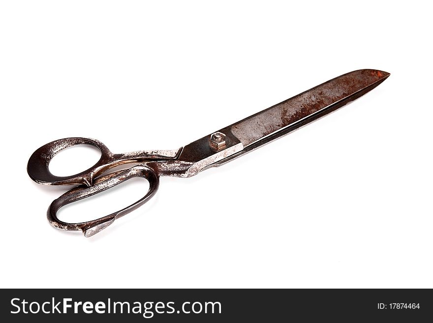 Old metallic scissors, isolated on white