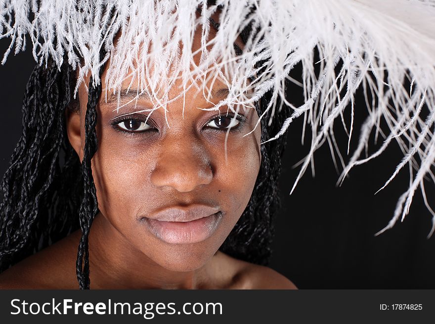 Afro-american woman with white feather against black background