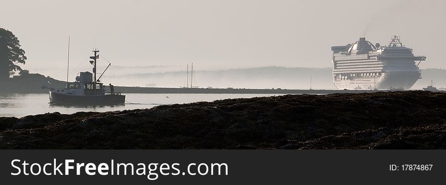 A lobster-boat heads out for a hard day at work while a cruise ship moors in the harbor in Acadia National Park. A lobster-boat heads out for a hard day at work while a cruise ship moors in the harbor in Acadia National Park.