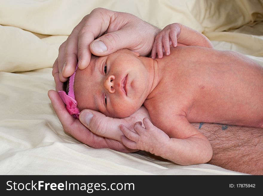 A cute little baby laying down with a pink bow. A cute little baby laying down with a pink bow.