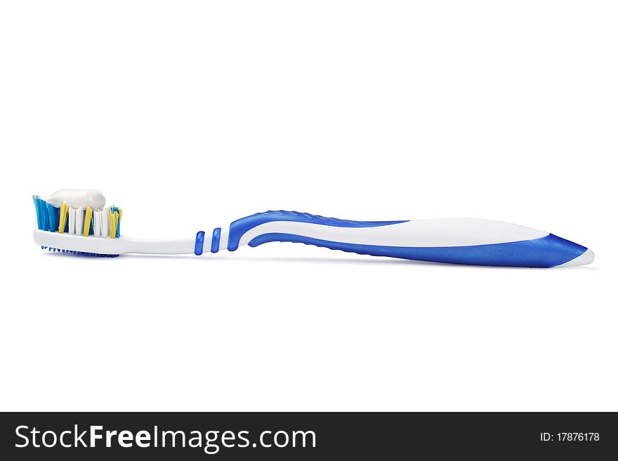 The tooth brush with tooth paste is isolated on a white background