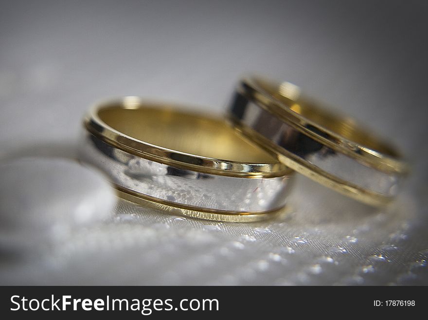 Two silver gold wedding ring placed on the waistcot. Two silver gold wedding ring placed on the waistcot