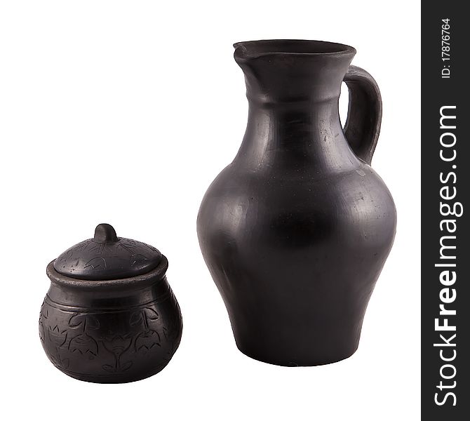 Pottery from black clay on white background