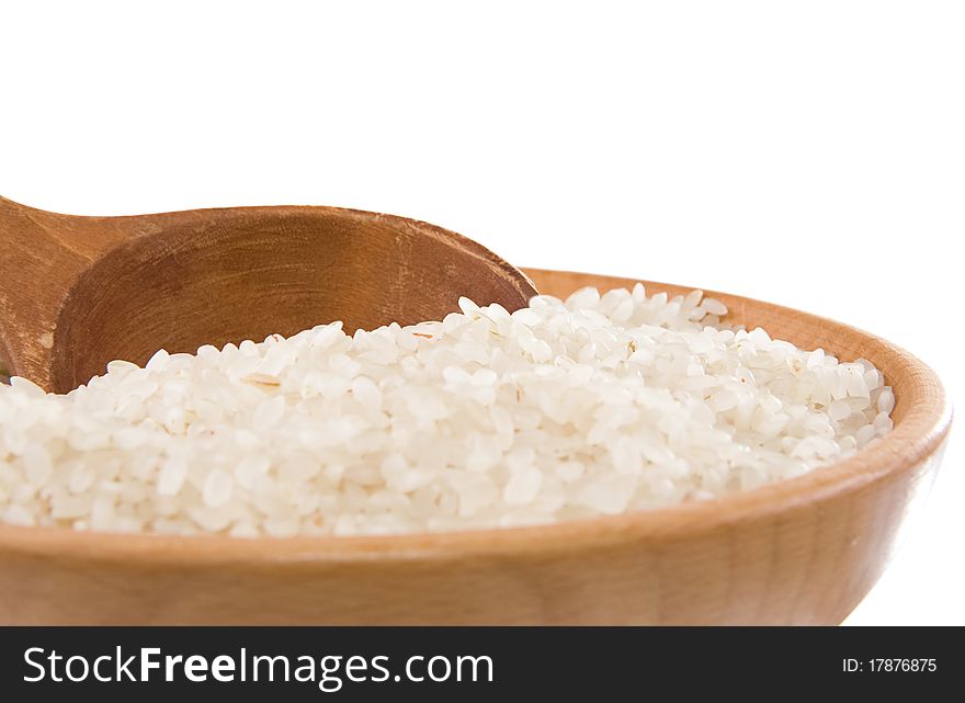Rice in wooden plate isolated on white background