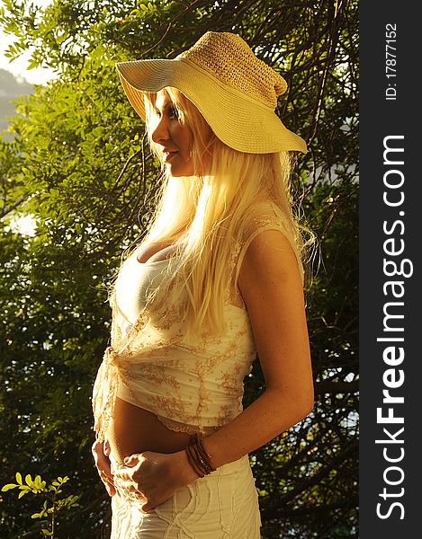 Woman in early pregnancy enjoying the morning light