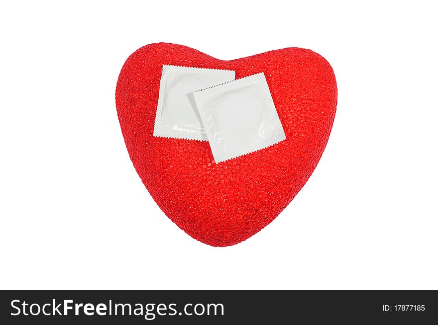 Red plastic heart with two condoms on it. Red plastic heart with two condoms on it