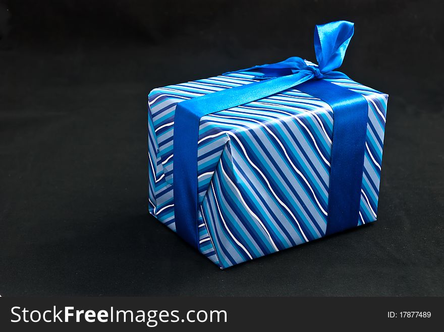 Blue paper gift box. On black background