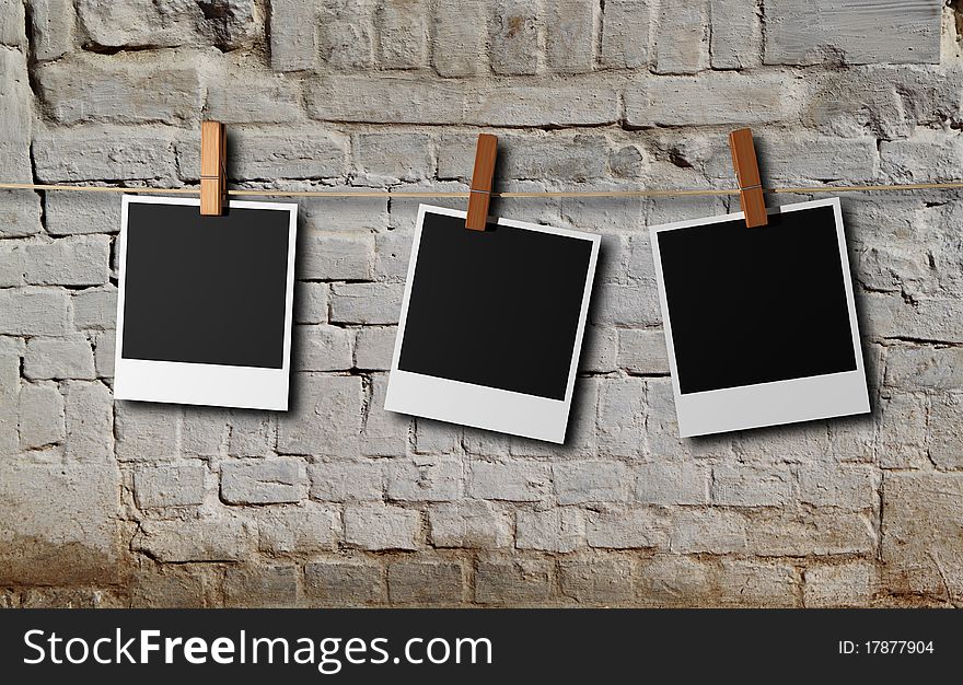 Three instant photos frame and white brick wall