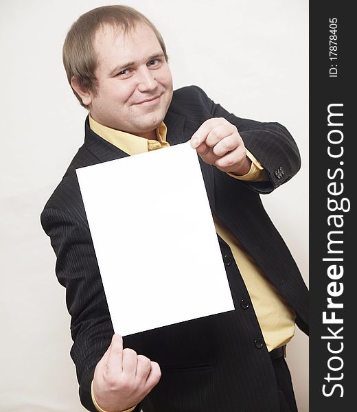 ManThe businessman of average years costs on a white background