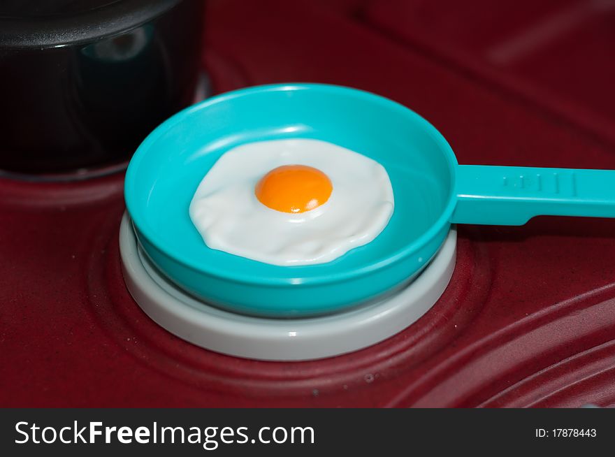 Plastic Toy Fried Egg in a Pan on a Stove