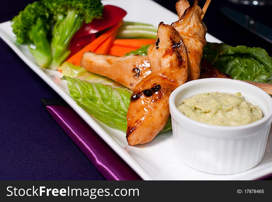 Chicken with Fresh Vegetables and Sauce served on a Plate. Chicken with Fresh Vegetables and Sauce served on a Plate