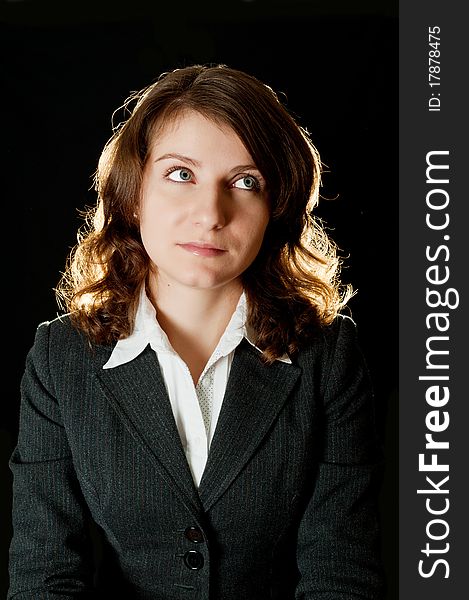 Portrait of women in business suit and white shirt on a black background