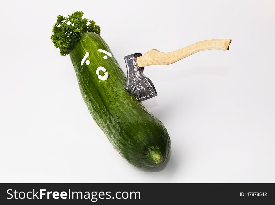 Cucumber with unhappy face and ax. Cucumber with unhappy face and ax