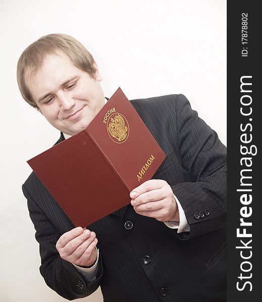 ManThe businessman of average years costs on a white background