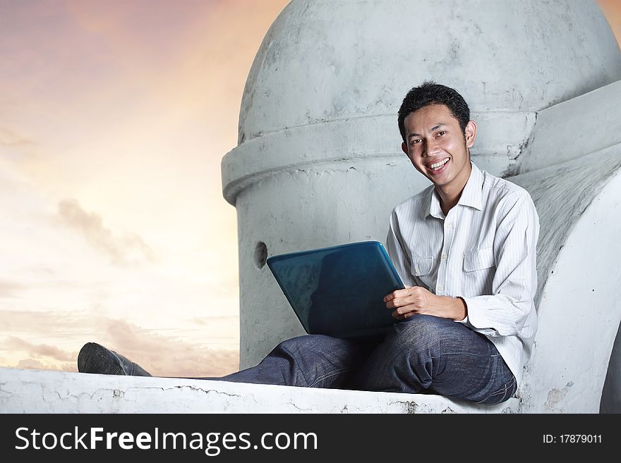 Man using notebook in sunset scenery. Man using notebook in sunset scenery