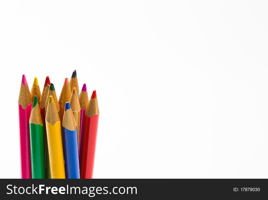Standing colored pencils against a white background