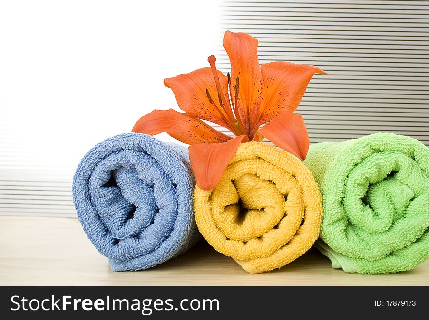 Colored towels are folded to lie next to them flower tiger lily