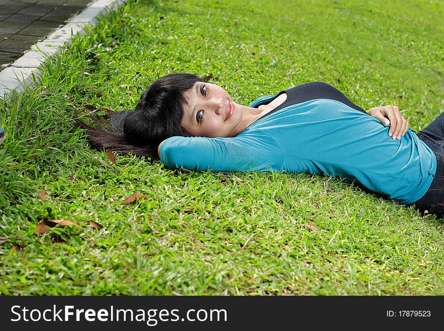 Young Beautiful Girl Smiling And Lying Down