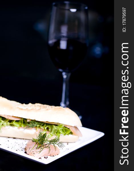 Long baguette sandwich with salmon and fresh vegetables. Long baguette sandwich with salmon and fresh vegetables