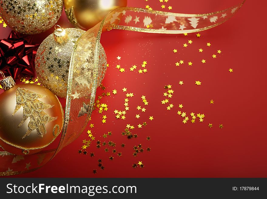 Gold and red Christmas balls in red background. Gold and red Christmas balls in red background