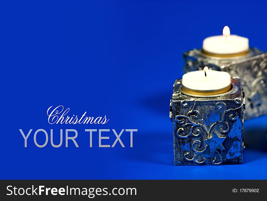 Silver Chrismas candle on blue background. Silver Chrismas candle on blue background