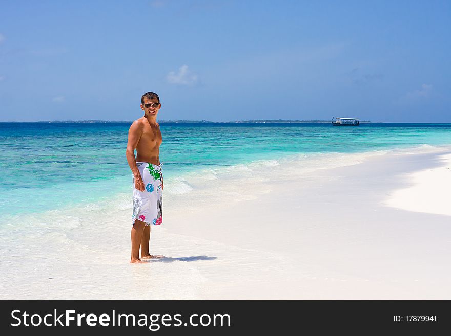 Young man on a wonderful tropical beach. Young man on a wonderful tropical beach