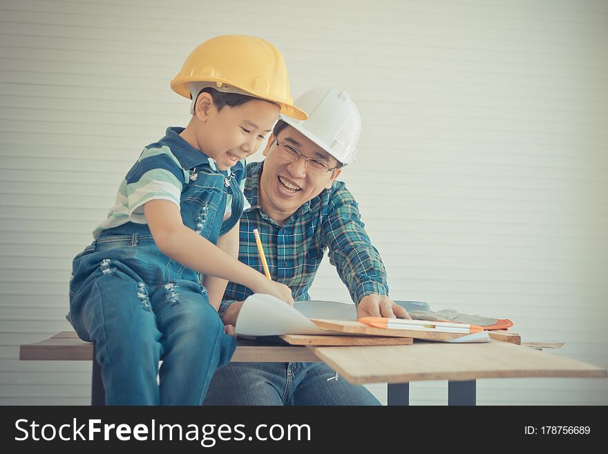 Father is teaching his son to fo the DIY home improvement work for parent and family bonding concept