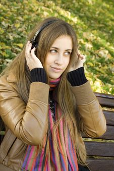 Young Woman With Headphones In The Park Royalty Free Stock Image Young Woman With Headphones In The Park Royalty Free Stock Image