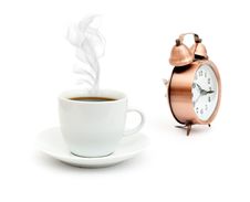 Vintage Alarm Clock And White Coffee Cup Royalty Free Stock Images