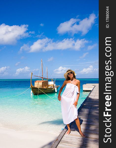 A young woman stands on a pier. A young woman stands on a pier