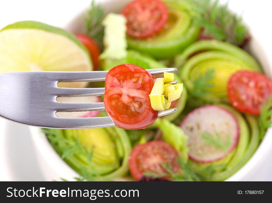 Some bits of salad on the fork close up. Some bits of salad on the fork close up