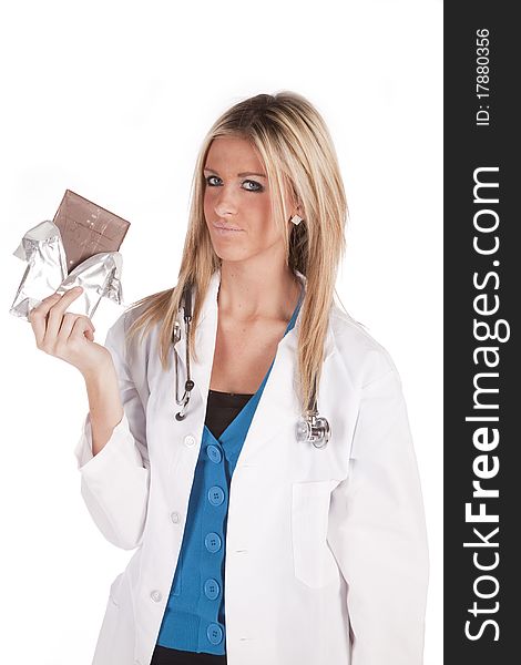 A woman doctor is holding up a big bar of chocolate. A woman doctor is holding up a big bar of chocolate.