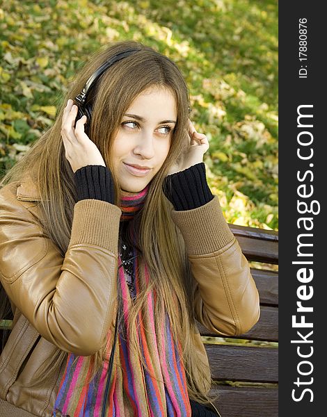 Young woman with headphones in the park