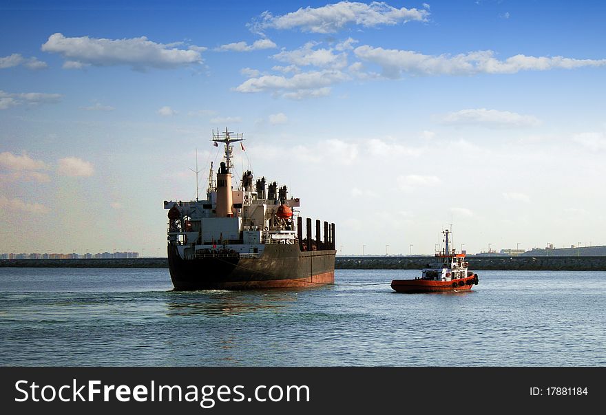 General cargo vessel helped for a tug. General cargo vessel helped for a tug