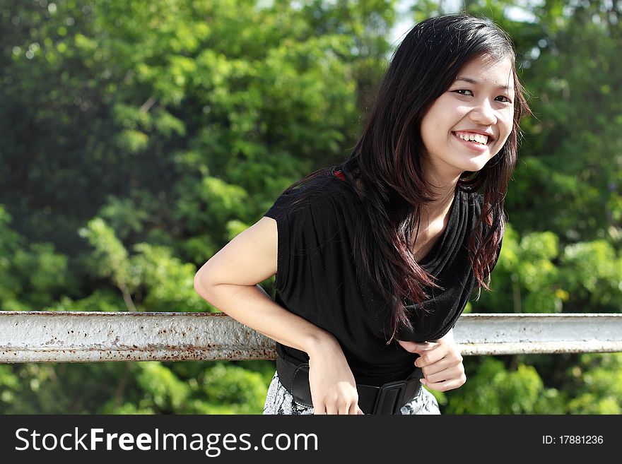 Attractive asian girl smiling in the park