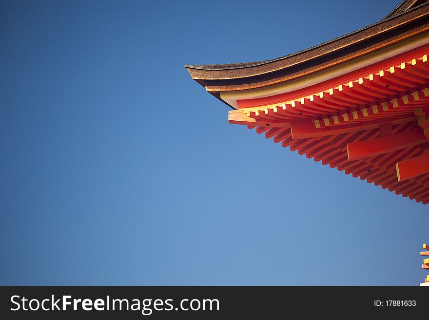 Asian roof detail over clear blue sky