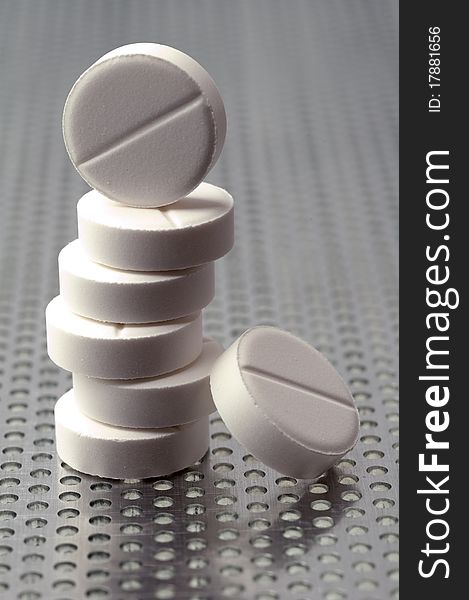 Pills on a perforated metal