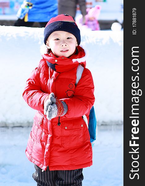 Asian boy is playing snow