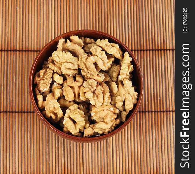 Shelled walnuts in a bamboo bowl