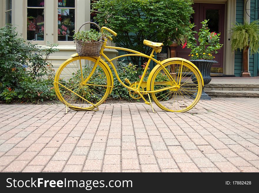 Decorative yellow bycicle with basket
