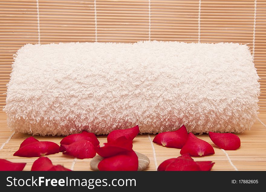 Spa scene with a towel and aromatic petals