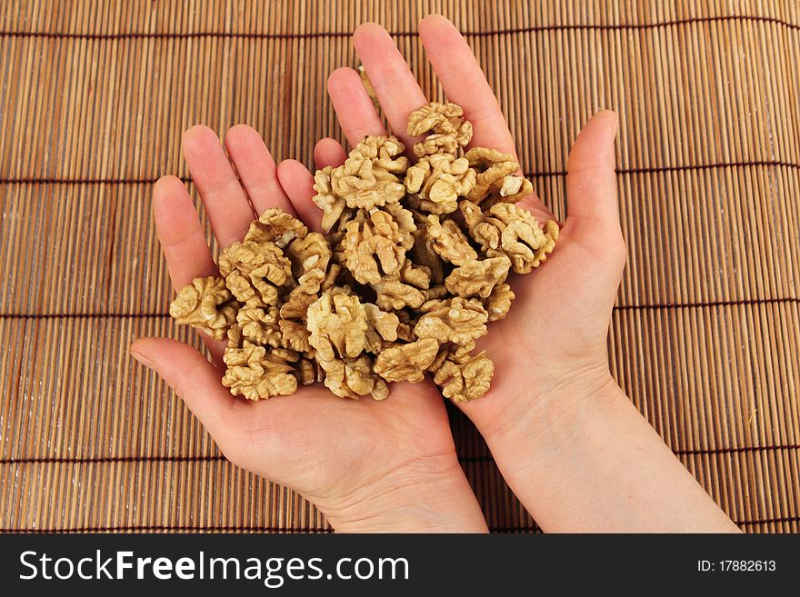 Shelled walnuts in the hands of a girl