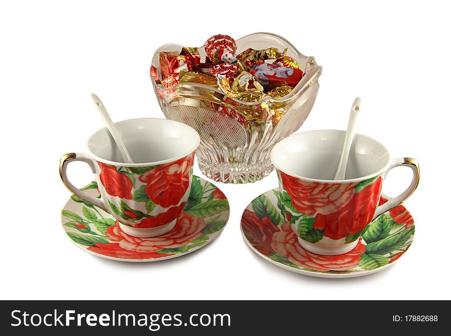 Two tea cups and vase with sweets. Two tea cups and vase with sweets
